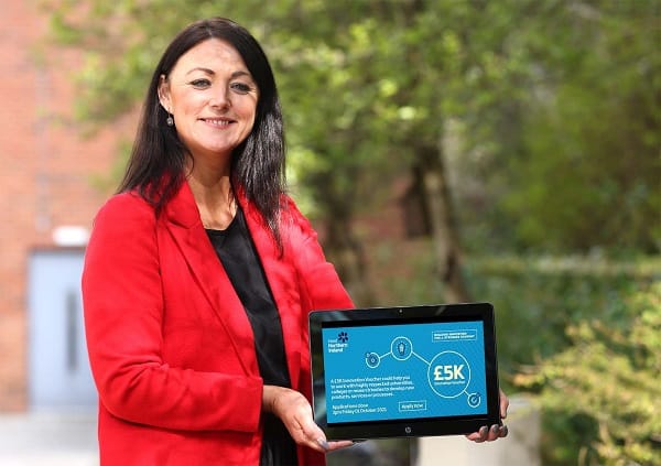 Elaine Flynn holding tablet promoting innovation voucher